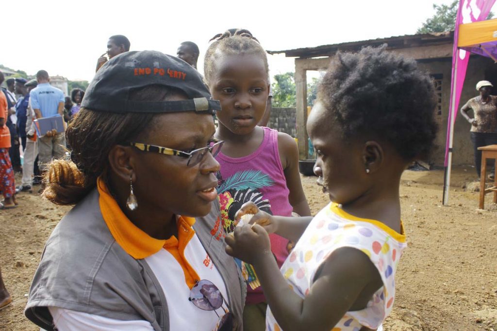 ActionAid Sierra Leone Country Director Maytou Ganda engages with children displaced by mudslides.