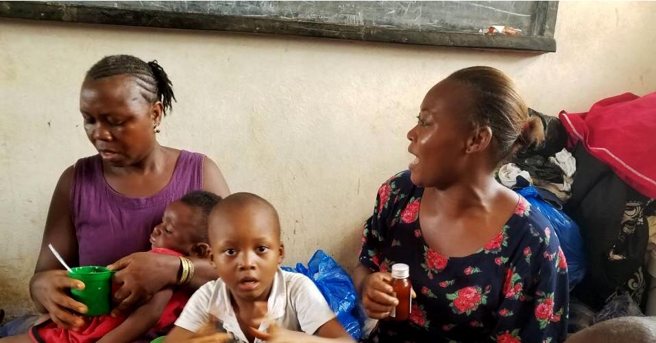 Women and children take shelter at a school after deadly mudslides in Freetown, Sierra Leone, in August 2017.