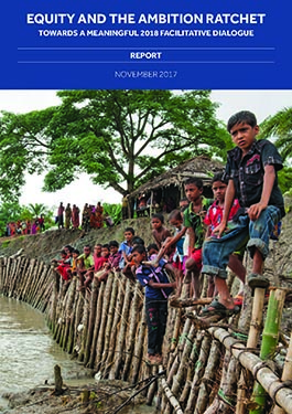 20 children sit atop a makeshift seawall in Patuakhali, Bangladesh. Bangladesh is doing more than its fair share of climate action.