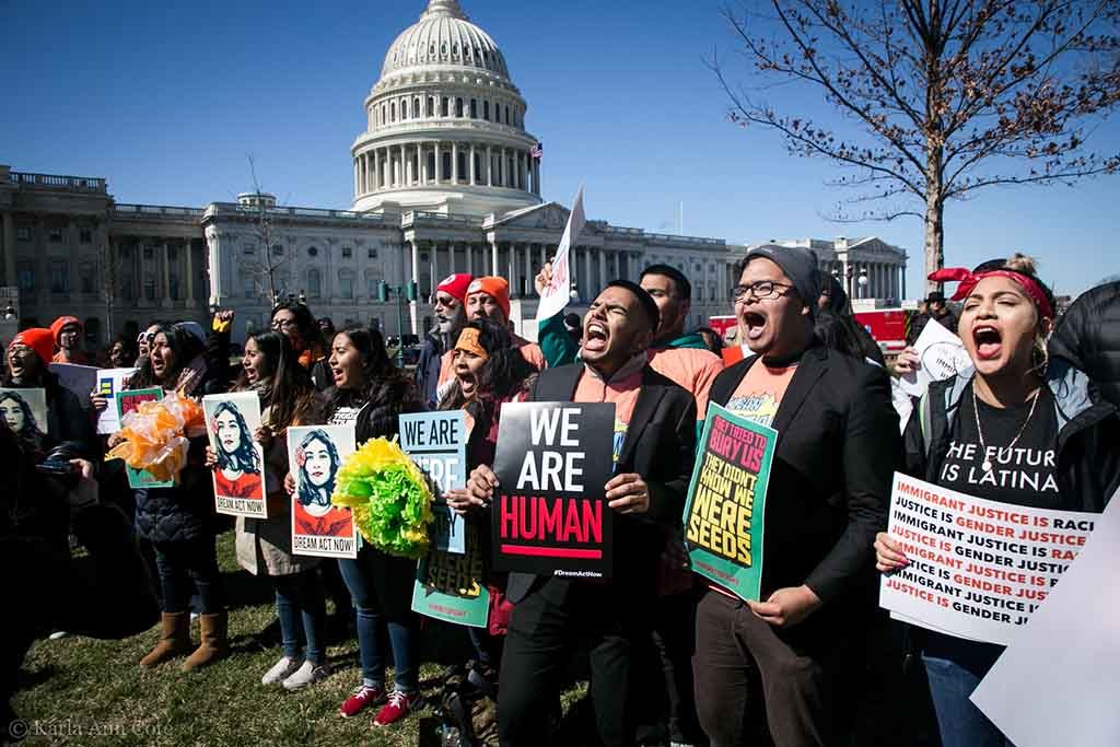 A crowd of immigrant youth stand in front of US Capitol in Washington DC to demand protections for their safety.