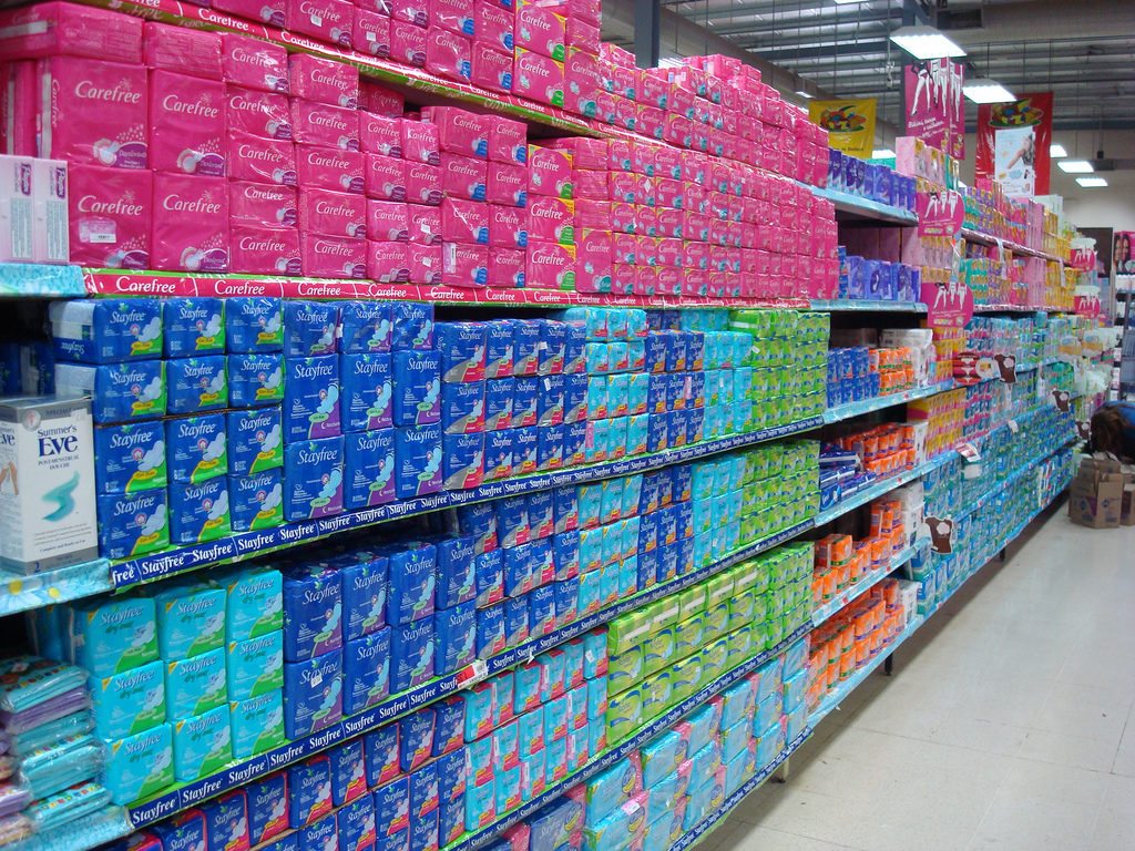 A grocery store aisle lined with packages of menstrual pads. Formerly incarcerated women in Arizona and state Representative Athena Salman campaigned for free, unlimited supply of menstrual products for female inmates.