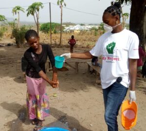 Activista member, right, demonstrating proper hand washing techniques to stop the spread of coronavirus