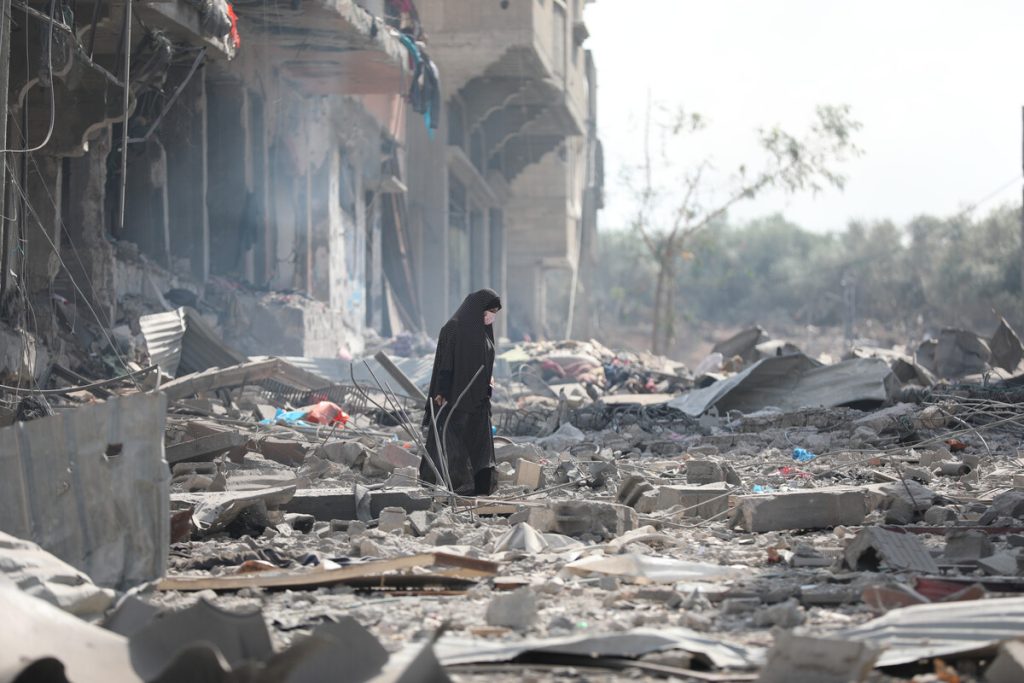 Woman resident of Gaza City searches the rubble for belongings in the aftermath of bombing by the Israeli army. 