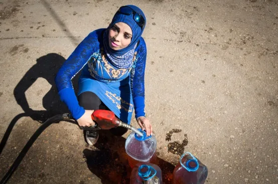 Amira sells and distributes fuel. Photo: Celia Peterson/ActionAid