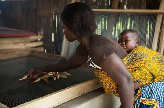 Delali smokes fish. She received food hygiene training from the project in Togo. Photo: Ruth McDowall/Shoot the Earth/ActionAid