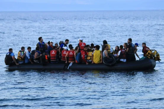 Refugees in a small boat land on a beach on the Greek island of Lesvos. Thousands have died trying to cross the Mediterranean Sea to Greece. Photo: Kelly Perrou/ActionAid