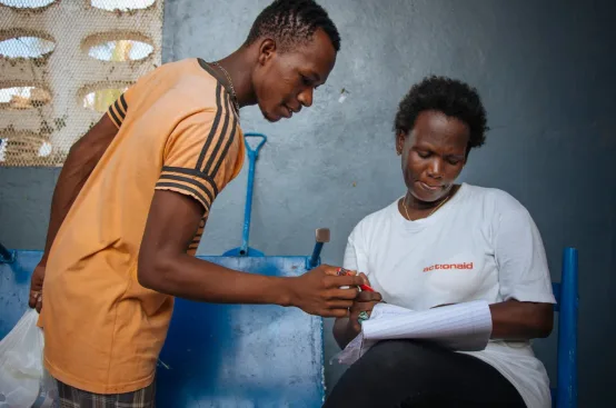 A young man collects emergency supplies from ActionAid staff. Photo: Dylan Roberts/FreeSociety/ActionAid