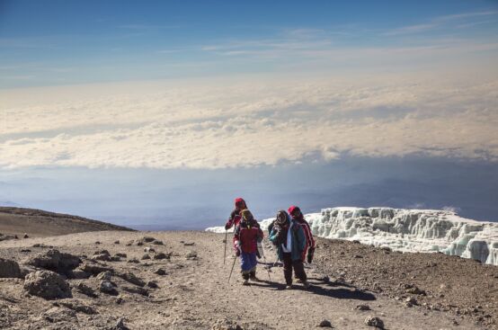 African women farmers stand atop Mt. Kilimanjaro, with the mountain’s famous glacier on the left. Photo: Georgina Goodwin/ActionAid