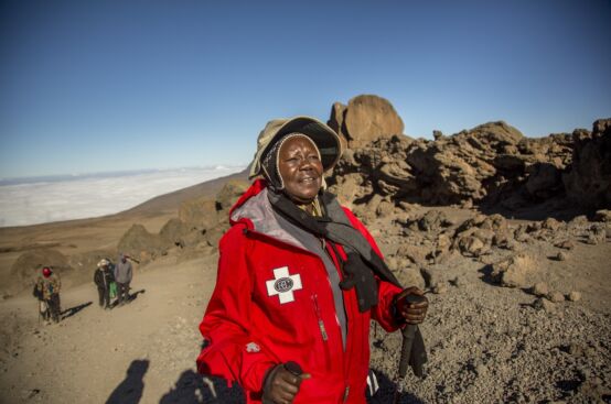 Polly, farmer and women’s rights activist from Uganda, makes her way towards Kibo Hut, close to Kilimanjaro’s summit. Photo: Georgina Goodwin/ActionAid