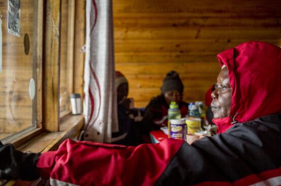 Polly, a farmer and women’s rights activist from Uganda, gazes out from Horombo Hut, situated halfway up Kilimanjaro. Photo: Georgina Goodwin/ActionAid
