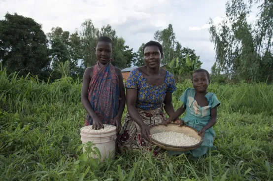 Tabia and two of her daughters with some of the maize harvested from their land irrigated by a GAFSP-funded project in Malawi. Photo: Eva-Lotta Jansson/ActionAid