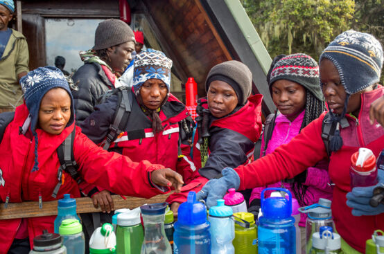 Climbers restock on supplies as they continue their ascent. Photo: Georgina Goodwin/ActionAid