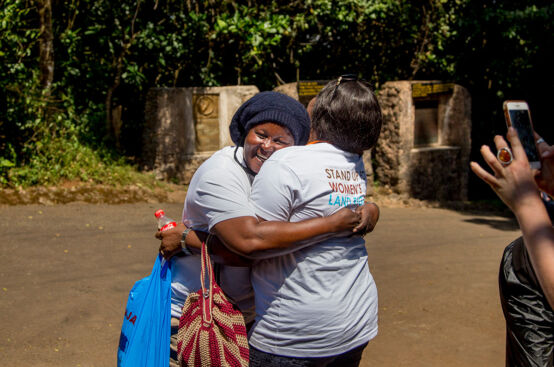 Mary, Kenyan land rights advocate, is greeted after her descent. Photo: Georgina Goodwin/ActionAid