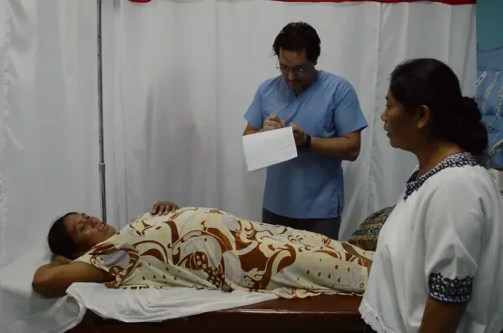 Alejandra Chen, right, translates during a medical appointment. Photo: ActionAid